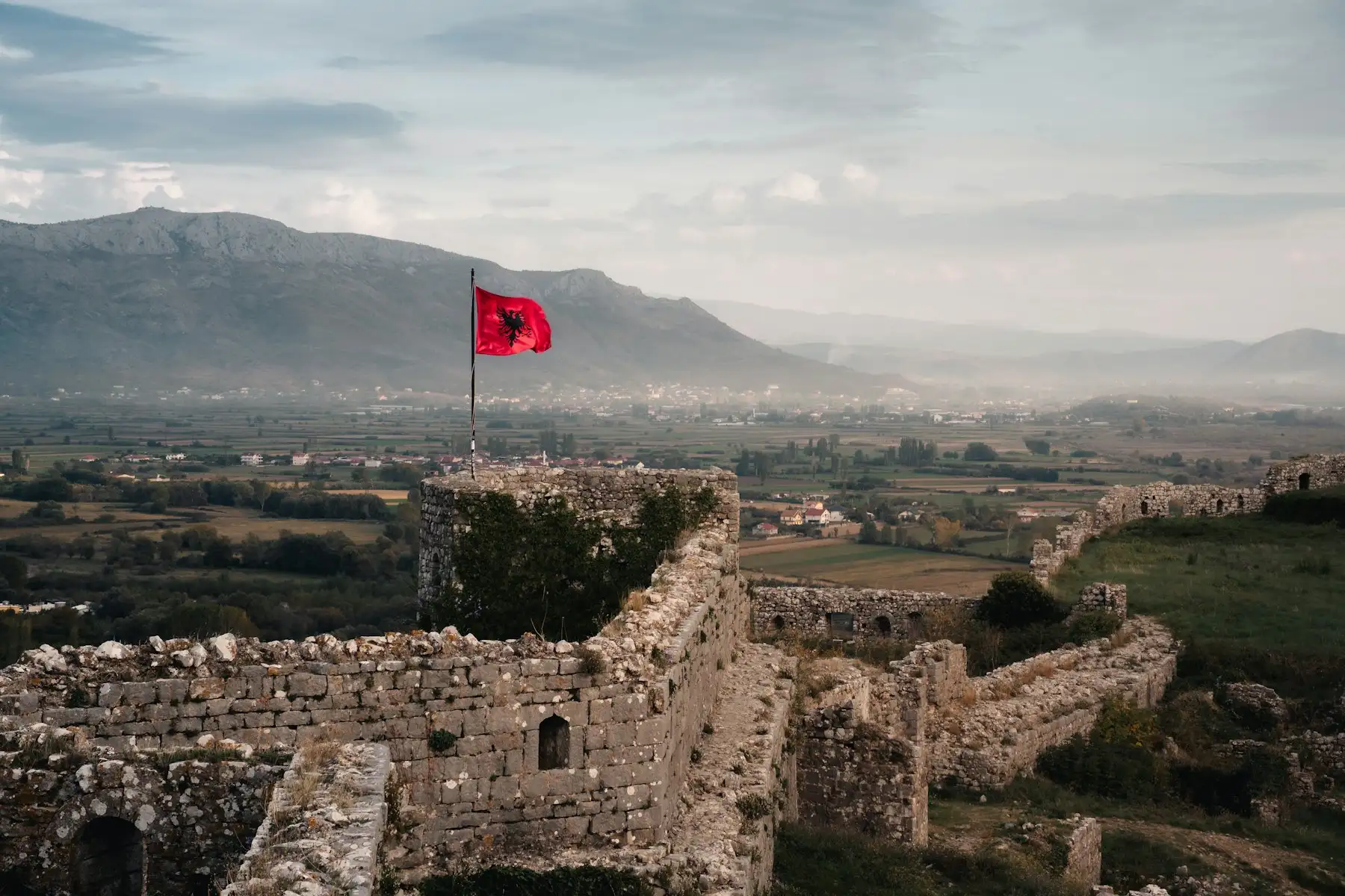 The walls of Rozafa Castle in Shkodra, with the Albanian flag