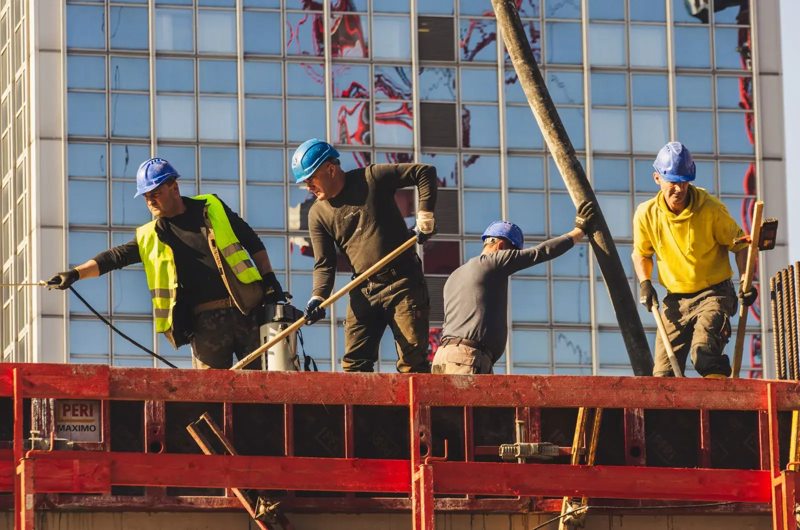 Construction workers in hard hats working on a building site