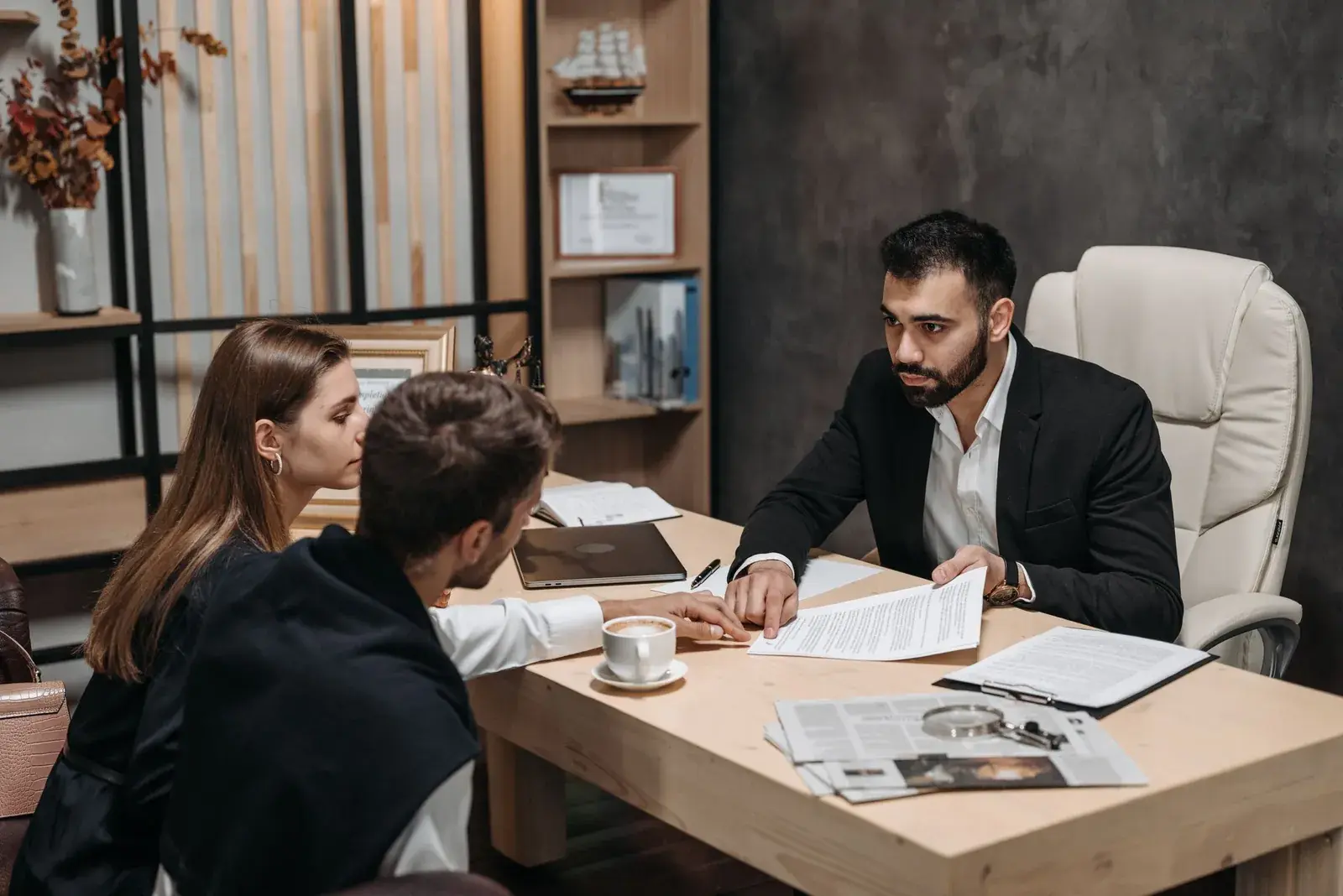 Couple going over property documents with a notary in an office