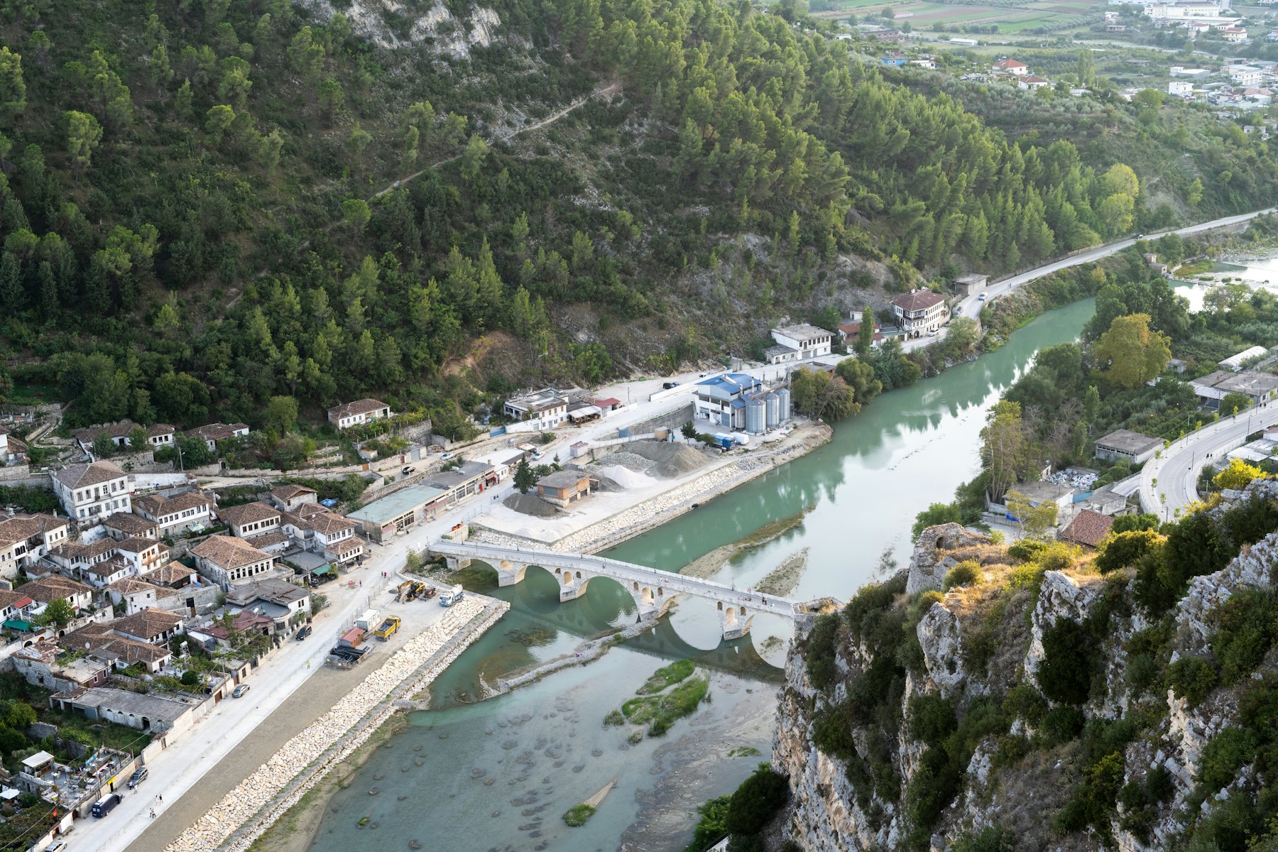 An aerial view shows a river and town