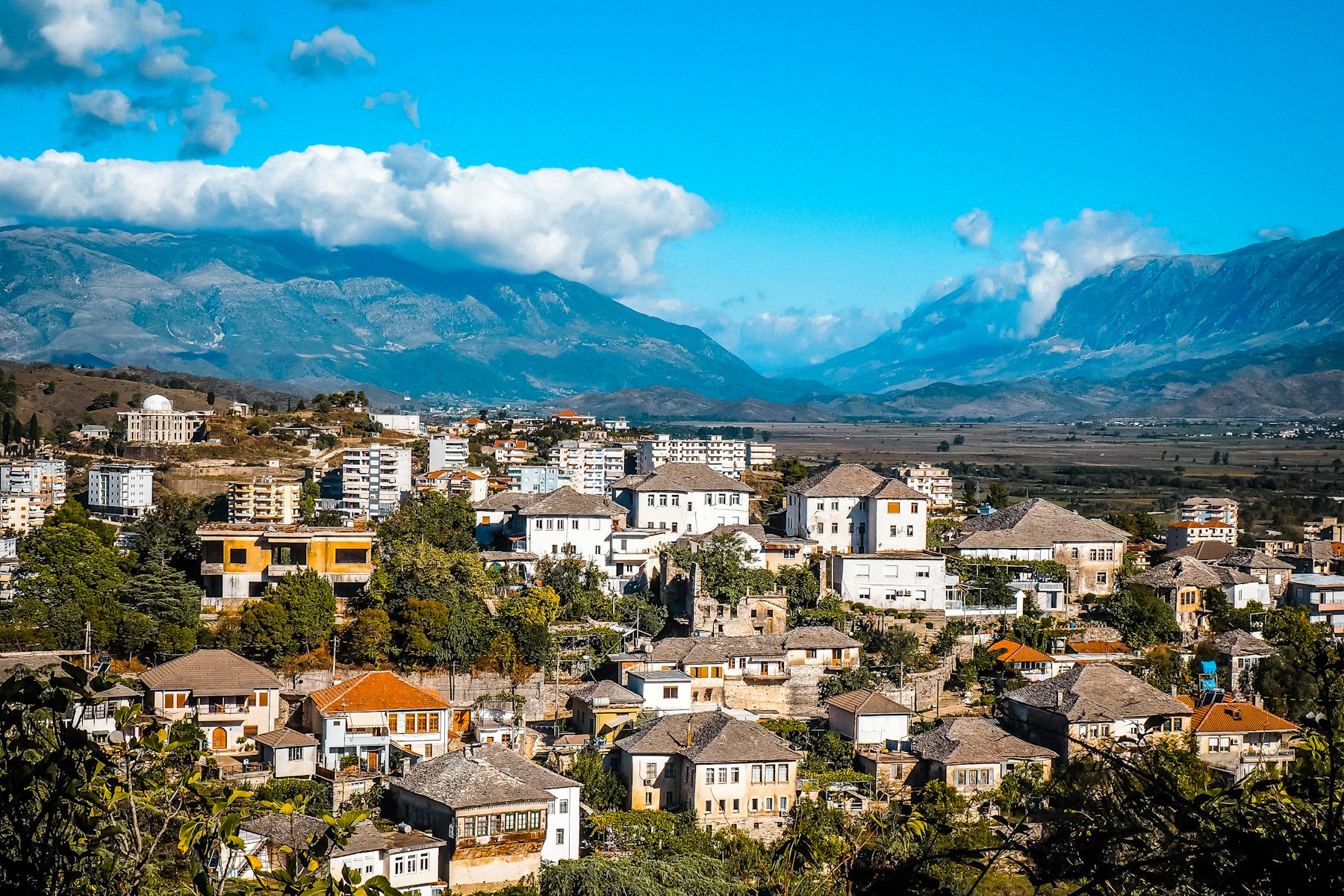 a view of a city with mountains in the background