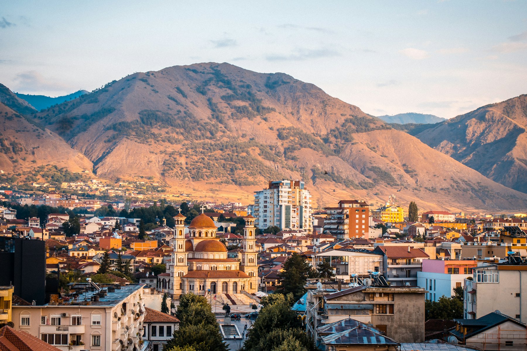 a city with mountains in the background