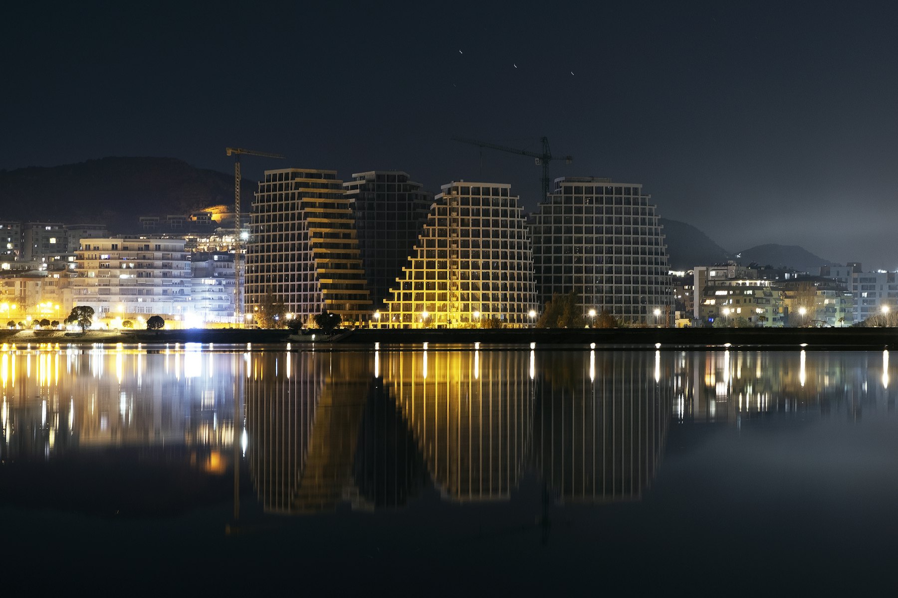 a large body of water with a city in the background